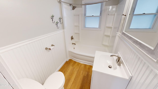 full bathroom featuring vanity, hardwood / wood-style flooring, shower / bathtub combination, and toilet