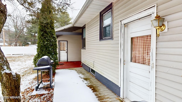 snow covered patio with area for grilling