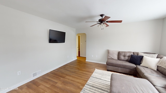 living room featuring ceiling fan and light hardwood / wood-style flooring