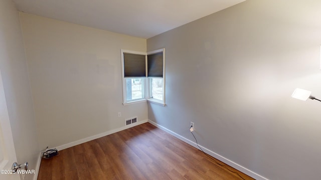 spare room featuring wood-type flooring