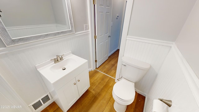 bathroom with vanity, wood-type flooring, and toilet