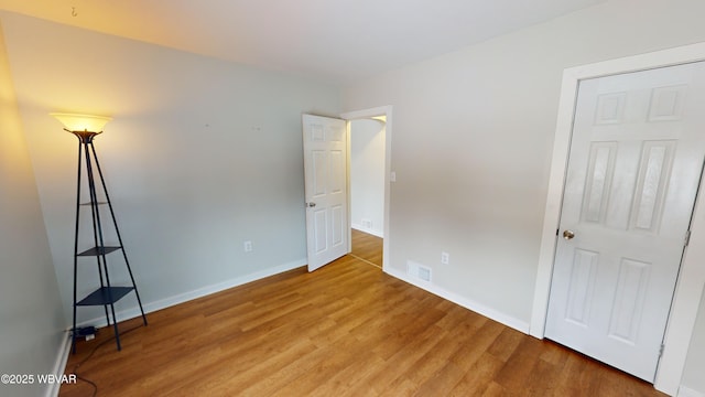 unfurnished bedroom featuring hardwood / wood-style flooring