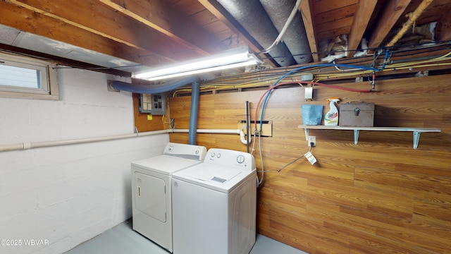 clothes washing area featuring electric panel and independent washer and dryer