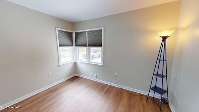 spare room with hardwood / wood-style floors