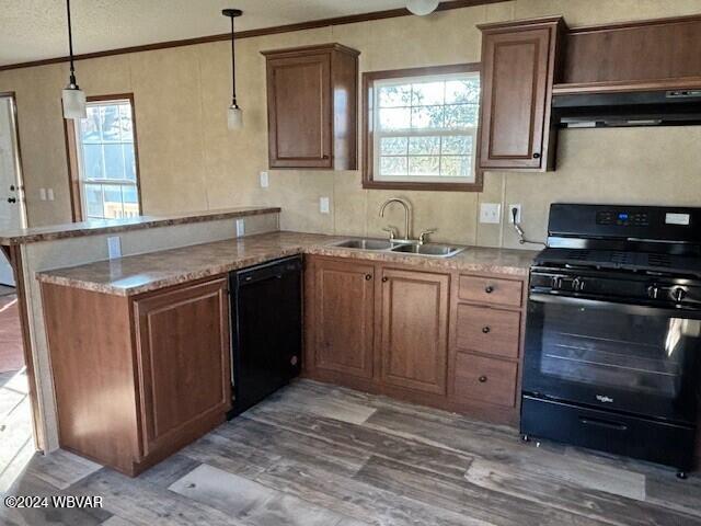 kitchen featuring kitchen peninsula, dark wood-type flooring, sink, black appliances, and pendant lighting