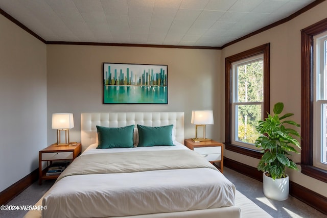 carpeted bedroom featuring crown molding