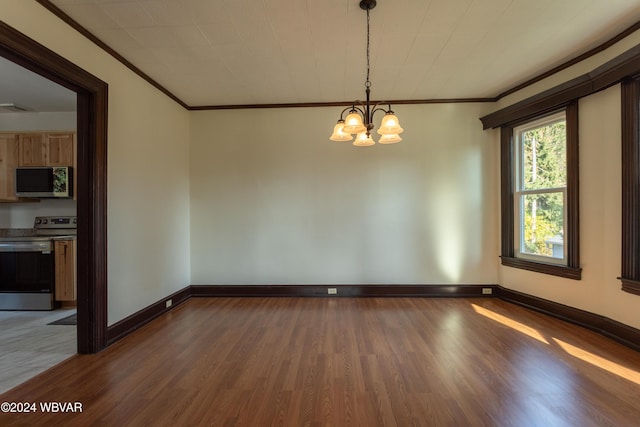 unfurnished room featuring a notable chandelier, wood-type flooring, and ornamental molding