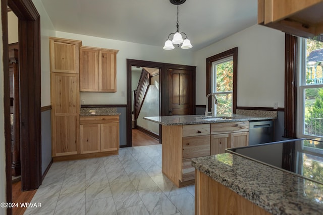 kitchen featuring stone counters, dishwasher, sink, an inviting chandelier, and decorative light fixtures