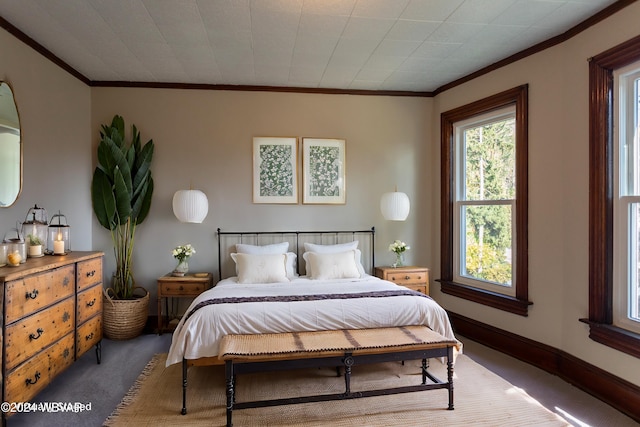 bedroom with carpet floors and crown molding