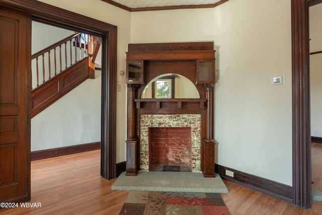 living room with crown molding and light hardwood / wood-style flooring