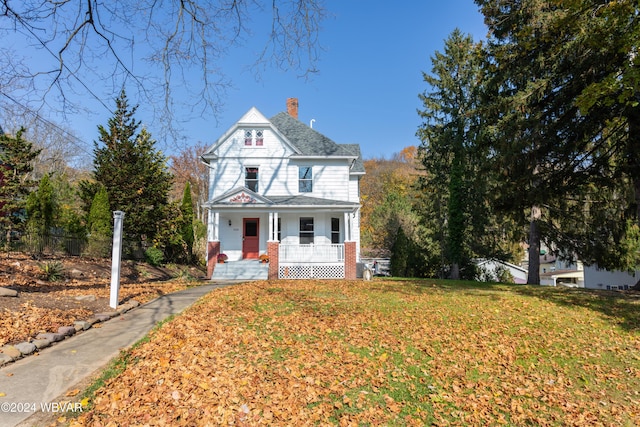 victorian home featuring a front yard and a porch