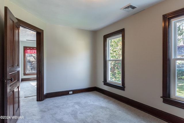 unfurnished room featuring light colored carpet