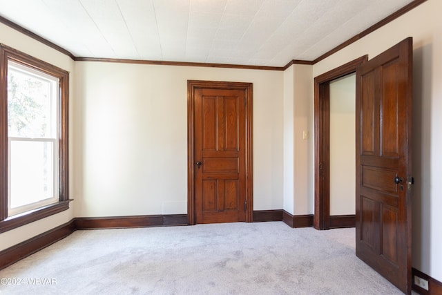 carpeted spare room with crown molding