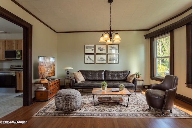 living room with hardwood / wood-style floors, crown molding, and a chandelier