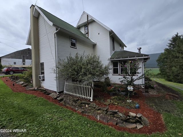 rear view of property with a yard