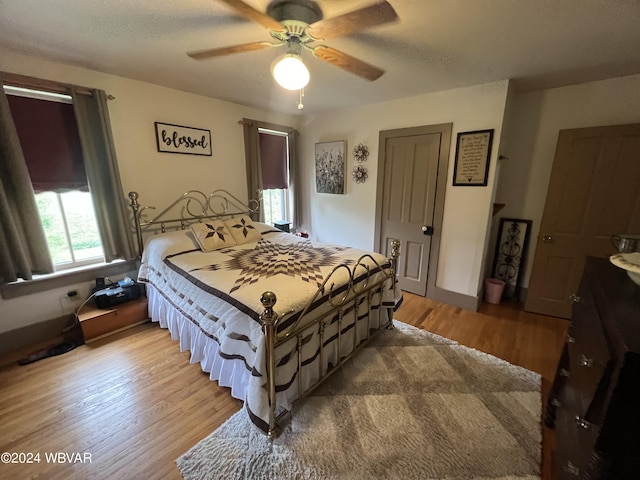 bedroom featuring ceiling fan and light hardwood / wood-style flooring