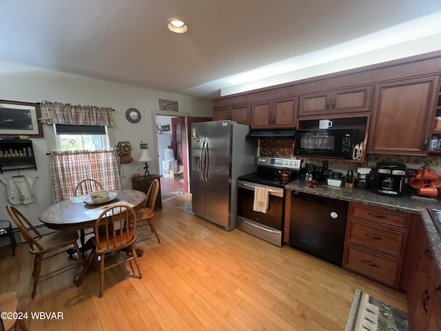 kitchen featuring black appliances, light hardwood / wood-style flooring, dark stone countertops, tasteful backsplash, and dark brown cabinetry