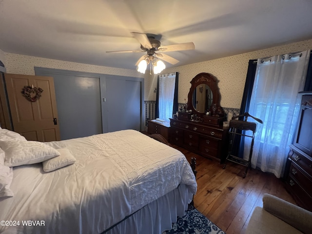 bedroom featuring ceiling fan and dark hardwood / wood-style floors