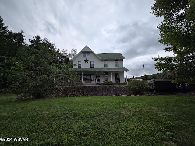 view of front of home with a porch and a front lawn