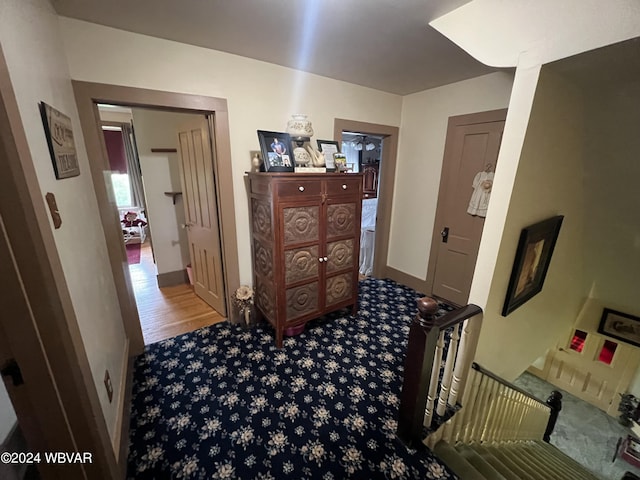 hallway with hardwood / wood-style flooring