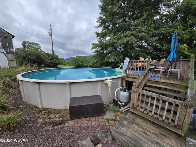 view of swimming pool with a wooden deck