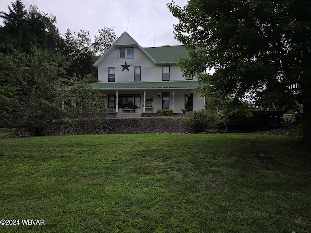 view of front of property with a porch and a front lawn