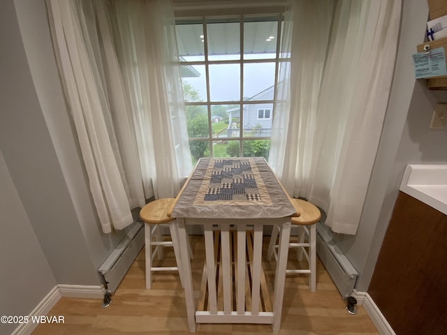 699 James St, Lock Haven, PA 17745 - dining space with baseboard heating, baseboards, and light wood finished floors