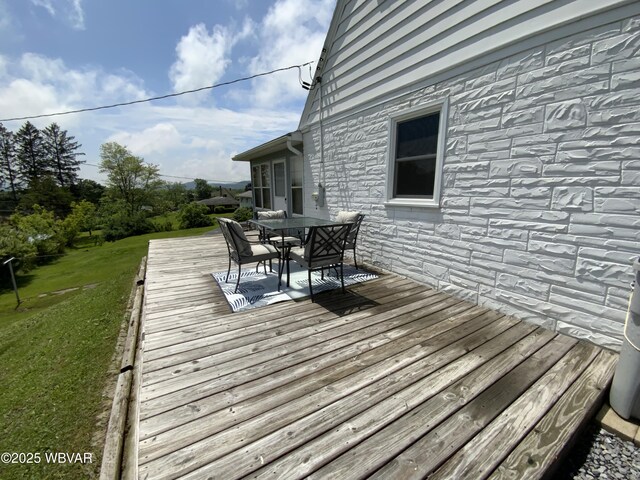 699 James St, Lock Haven, PA 17745 - wooden deck featuring outdoor dining space and a yard