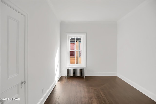 unfurnished room with dark hardwood / wood-style floors, ornamental molding, and radiator