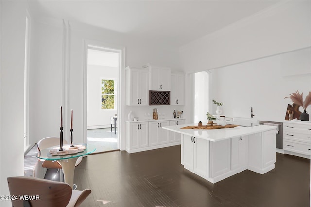 kitchen with white cabinets, dark hardwood / wood-style flooring, and a center island