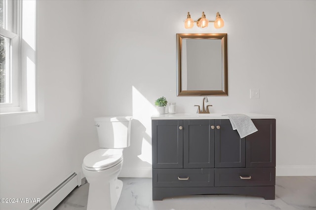 bathroom with vanity, toilet, and baseboard heating