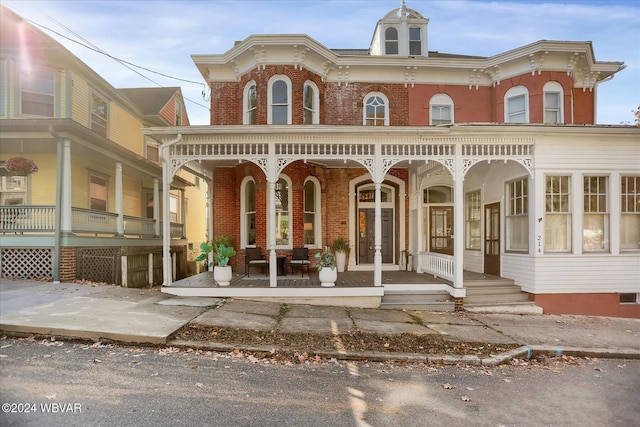 back of property featuring covered porch