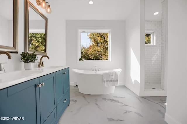 bathroom with vanity and independent shower and bath