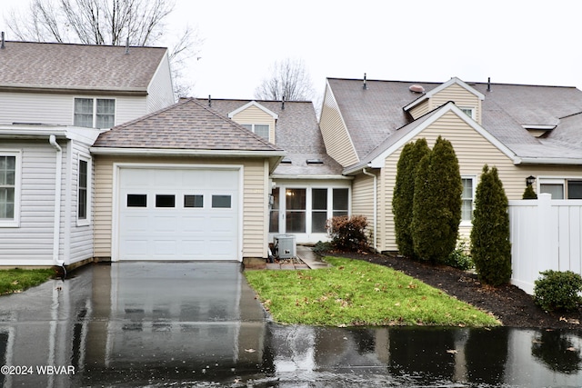 view of front facade featuring central AC and a garage