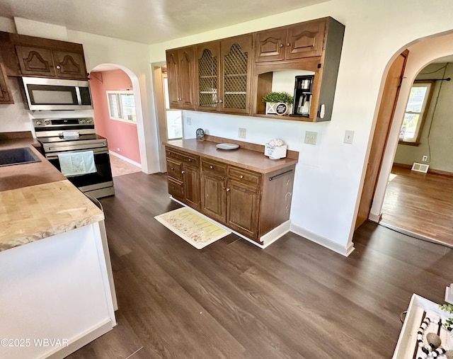1420 Richards Ave, Williamsport, PA 17701 - kitchen featuring appliances with stainless steel finishes, arched walkways, dark wood-style floors, and light countertops