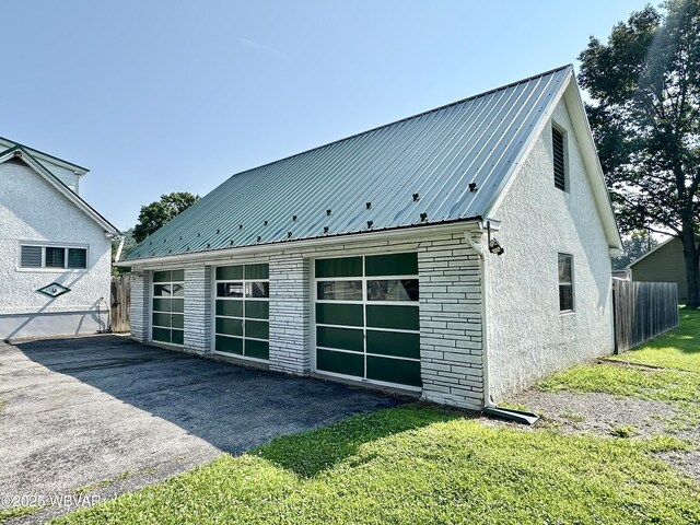 1420 Richards Ave, Williamsport, PA 17701 - view of side of home with a garage, a metal roof, and an outdoor structure