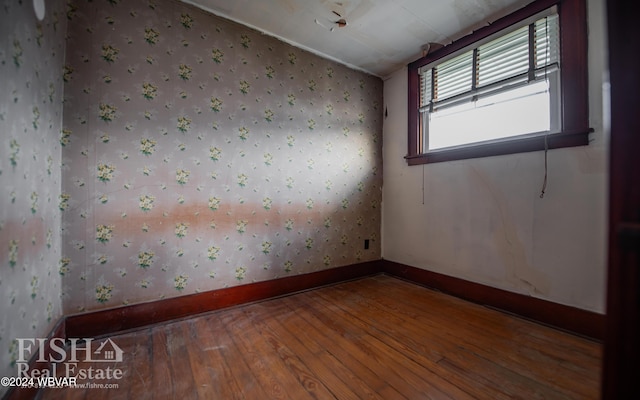 unfurnished room featuring hardwood / wood-style flooring