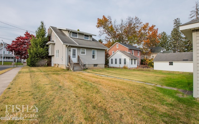 rear view of house featuring a yard