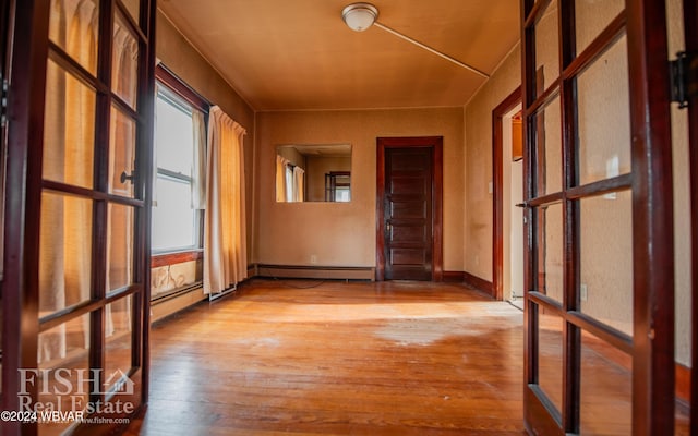 hallway featuring light hardwood / wood-style floors and a baseboard heating unit