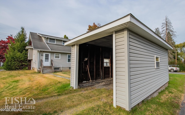 view of outbuilding with a yard