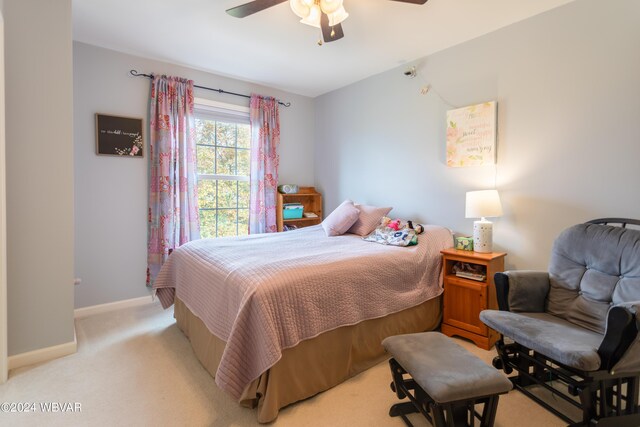 bedroom with ceiling fan and light colored carpet