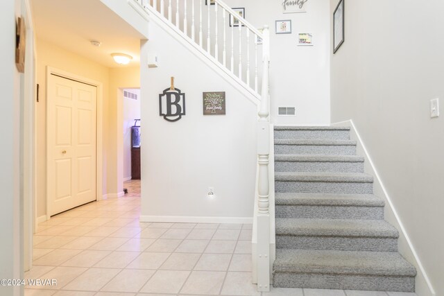 stairway featuring tile patterned flooring