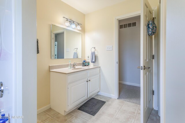 bathroom with tile patterned flooring and vanity