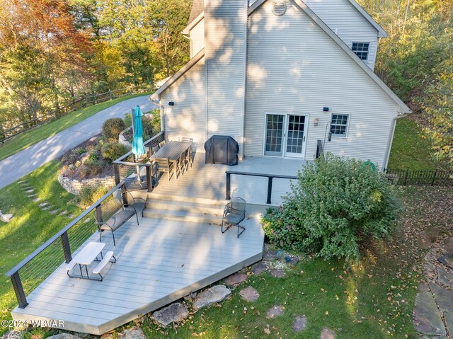 rear view of house featuring a deck