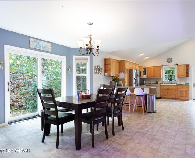 dining room with an inviting chandelier and lofted ceiling