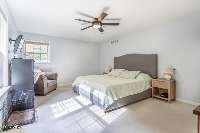 bedroom with light carpet and ceiling fan