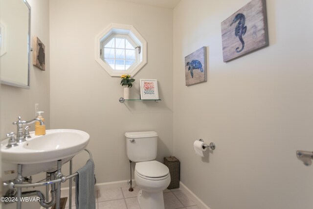 bathroom with tile patterned flooring, toilet, and sink