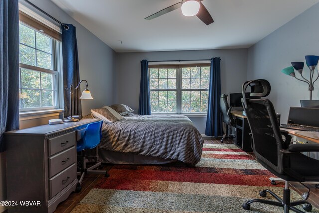 bedroom featuring ceiling fan and dark wood-type flooring