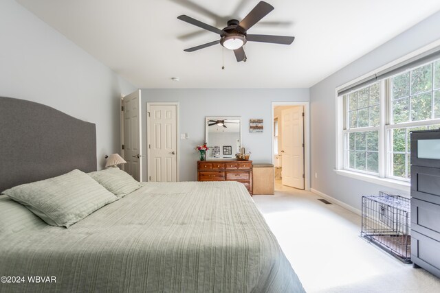 bedroom with ceiling fan and light carpet