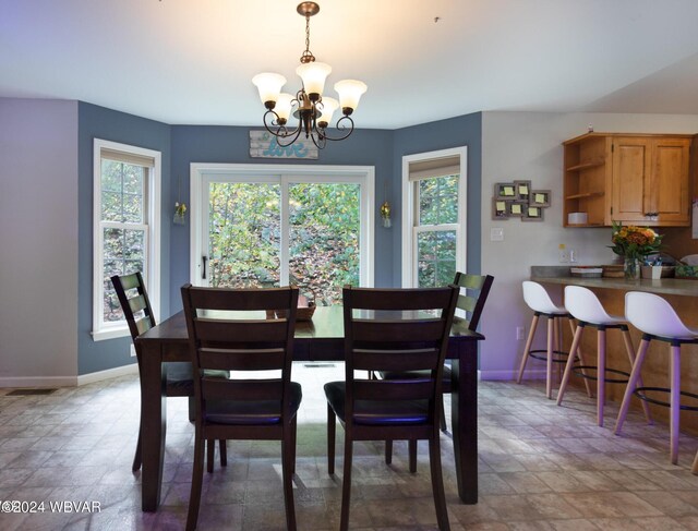 dining space featuring a notable chandelier